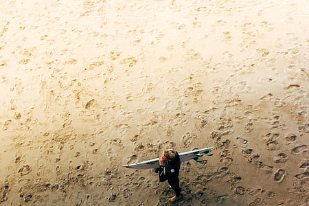person, holding, white, surf, board, beach, sand