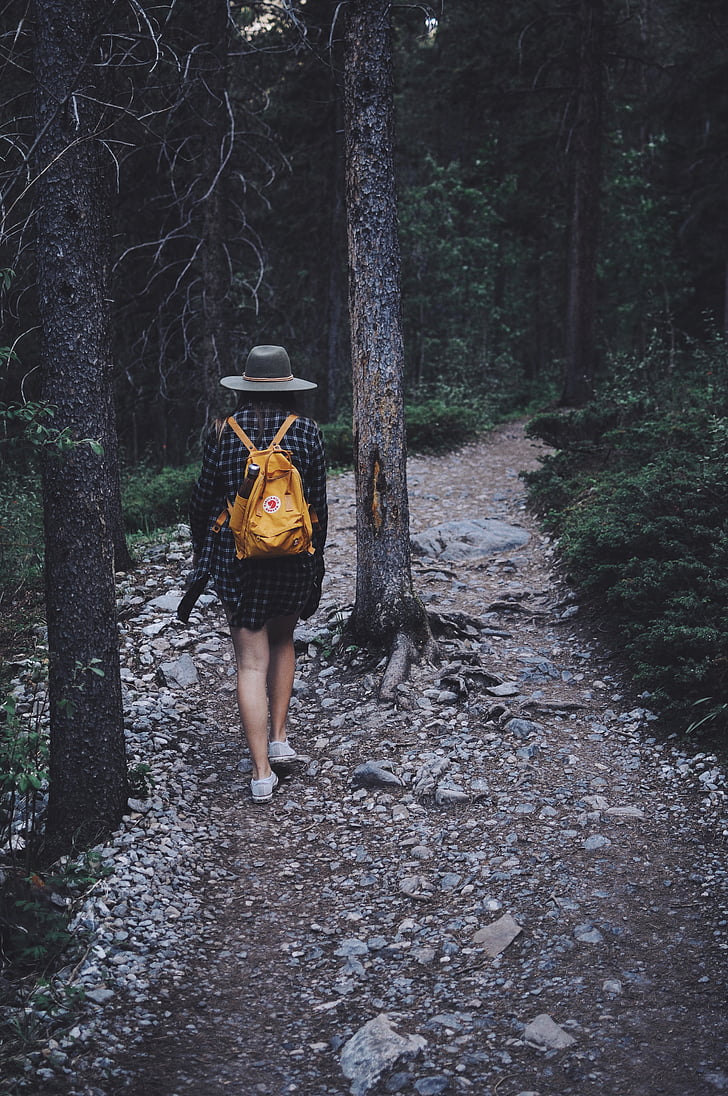 woman, wearing, brown, leather, backpack, walking, trees