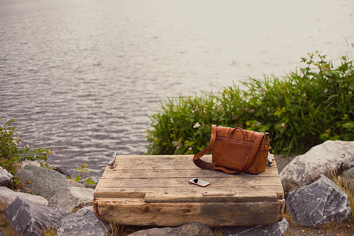 brown, leather, bag, rectangular, wooden, board, stones