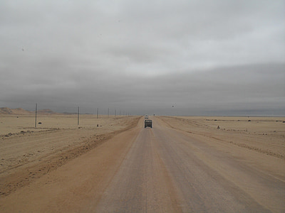 grey sky, salt road, lone vehicle, earthy colors, veld, vastness, desert