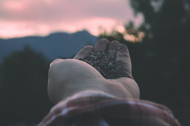 hand, mountains, nature, red sky, rocks, sky, sunset