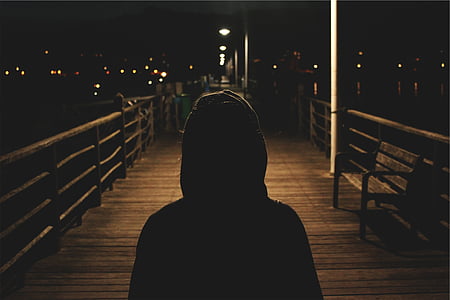 silhouette, person, hoodie, standing, lighted, bridge, daytime
