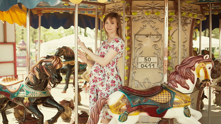 girl on carousel, horse, pregnant, dress, girl, vacation, photoshoot