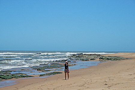 lady on beach, sea, waves, shore, beach, sand, rocks