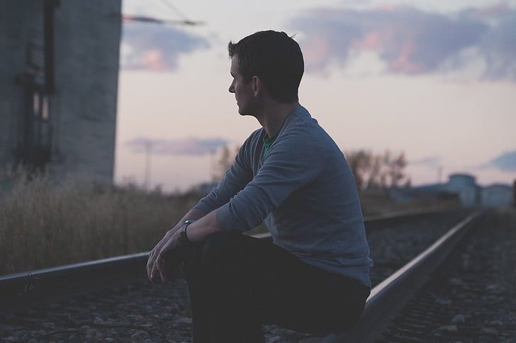 man, person, railway, sitting, one person, side view, outdoors