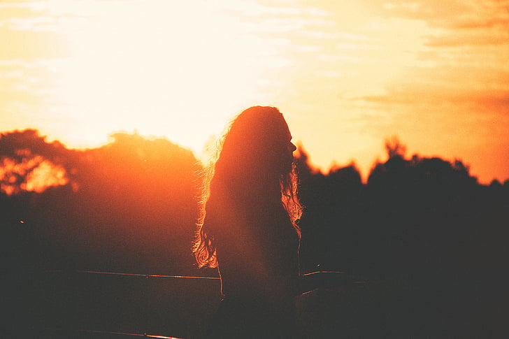 woman, standing, sunset, sun rays, dusk, silhouette, shadow