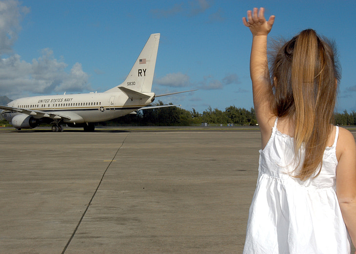 child waving goodbye, departure, plane, family, girl, little, sad