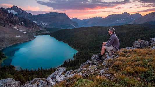 person, gray, sweater, sitting, top, mountain, lake