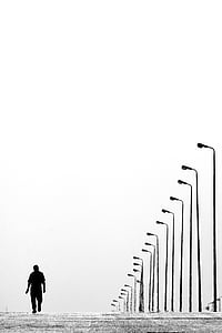 alone, black-and-white, lampposts, lamps, man, road, street lamps