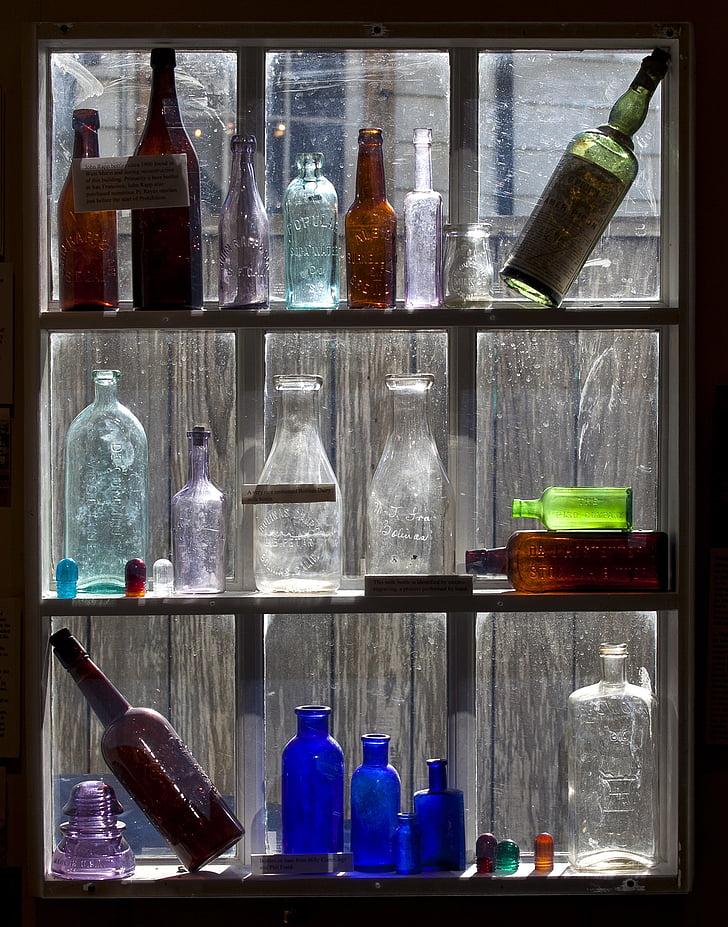 old bottles, display, colored glass, glass, old, vintage, wood