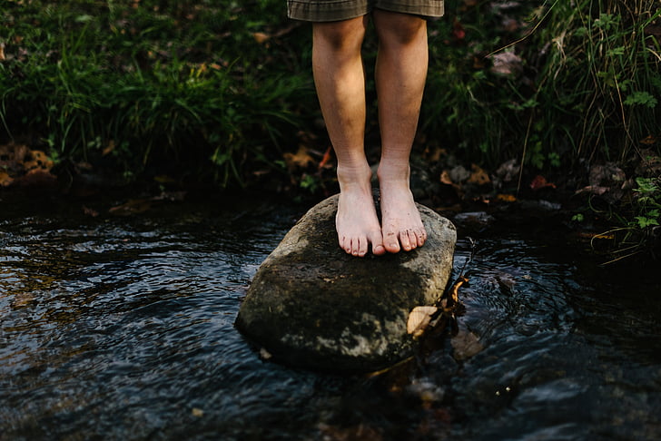 feet, grass, nature, person, rock, stream, water