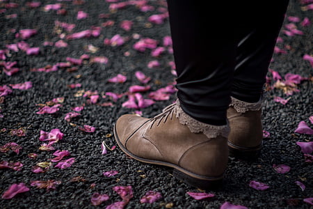 person, wearing, brown, boots, purple, petals, pavement