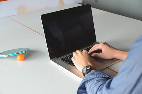 person, blue, dress, shirt, sitting, facing, laptop