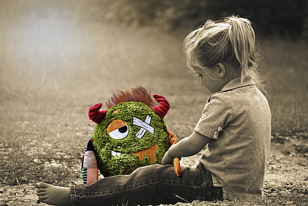 little girl, toddler, sitting, monster, stuffed animal, green, sepia