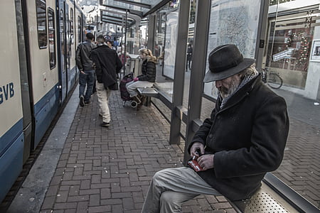 man, wearing, coat, hat, sitting, train, station