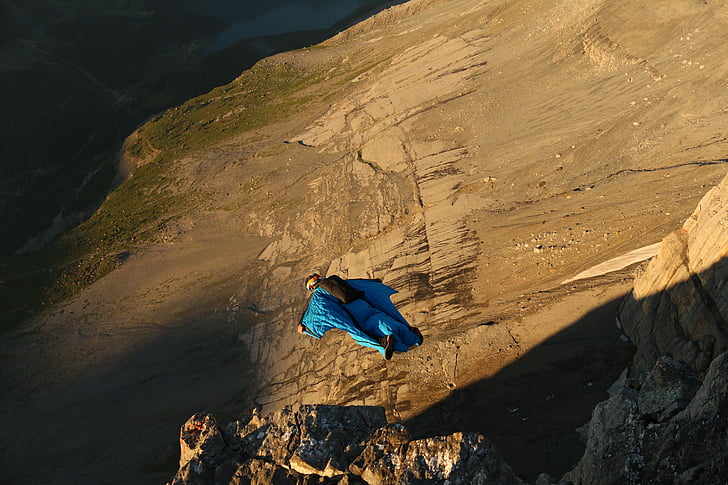 person, blue, suit, cliff, diving, daytime, mountain