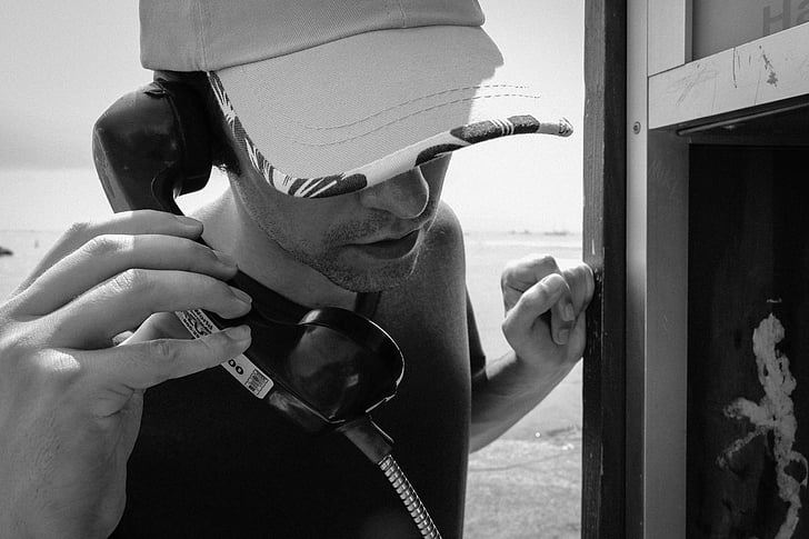 man, male, person, phone, pay phone, booth, hat