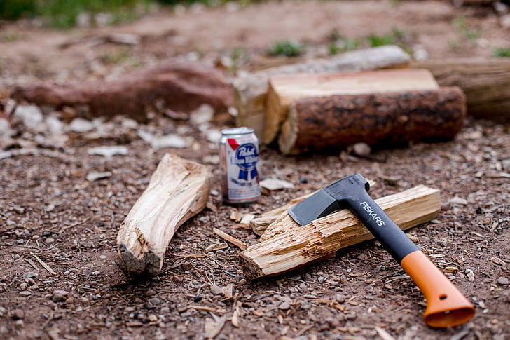 pabst, tin, can, beside, firewood, hatchet, axe