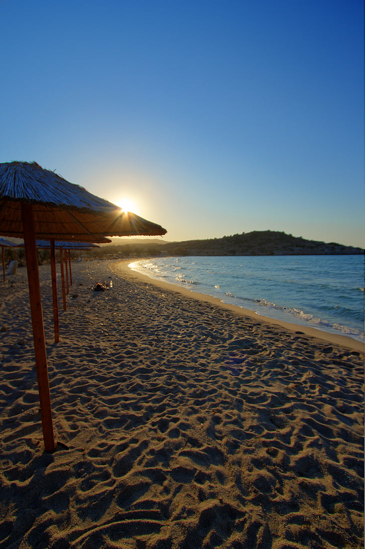milos, island, greece, beach, umbrellas, sandy, sunset