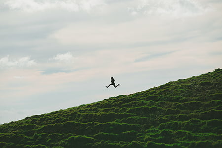 grass, jumping, landscape, mountain, outdoors, person, silhouette