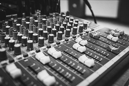 adjusting, audio, black-and-white, close-up, console, knobs, mixer