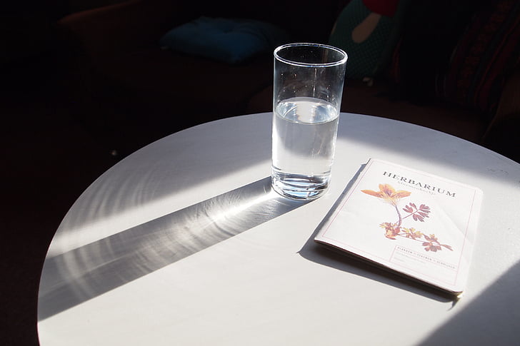 glass, glass of water, sun, shadow, reflection, booklet, table