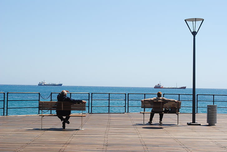 looking at ships, sitting on dock, sitting, benches, outdoors, view, sea