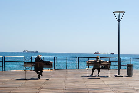 looking at ships, sitting on dock, sitting, benches, outdoors, view, sea