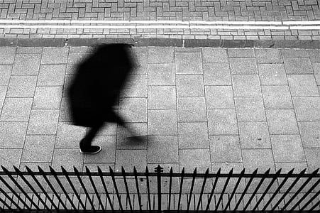 person, wearing, black, pants, walking, gray, concrete