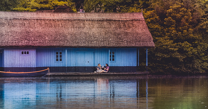 two, person, sitting, house, balcony, beside, lake