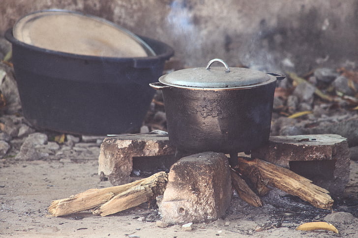 pots, fire, smoke, firewood, rocks, outdoor, cooking
