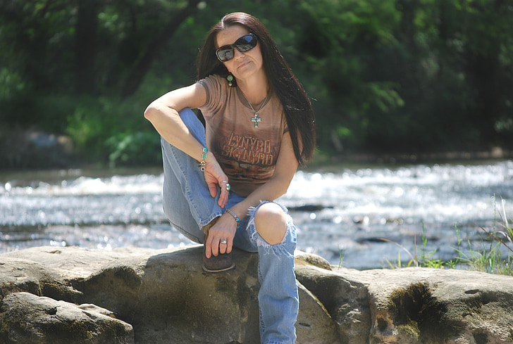woman, jeans, goggles, sunglasses, sitting, rock, pose