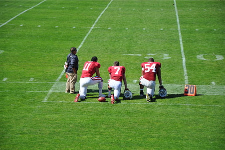 three, american, football, players, kneeling, field, beside