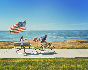 American flags, beach, bench, bicycle, bike, coast, fourth of july