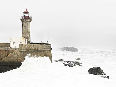 brown, lighthouse, covered, snow, daytime, ocean, sea