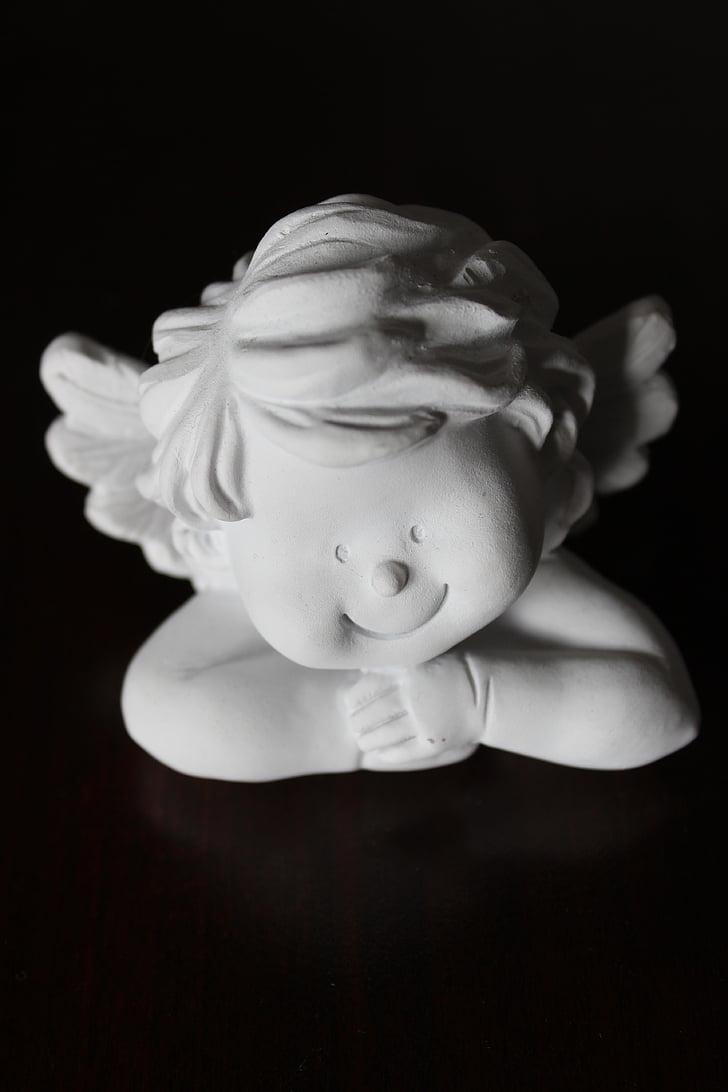 white, ceramic, cherub, figurine, top, black, surface