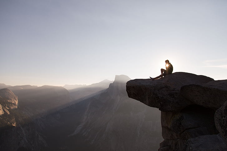 person, sitting, cliff, white, cloudy, sky, daytime