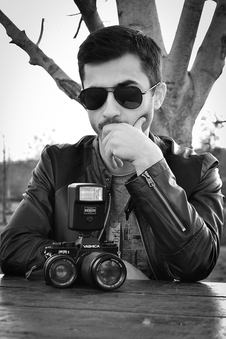 young man, old camera, glasses, serious, thinking, photo, boy