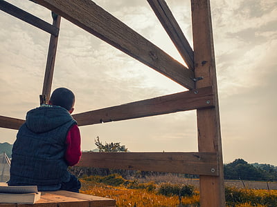 man, sitting, brown, wooden, bench, outdoor, tower