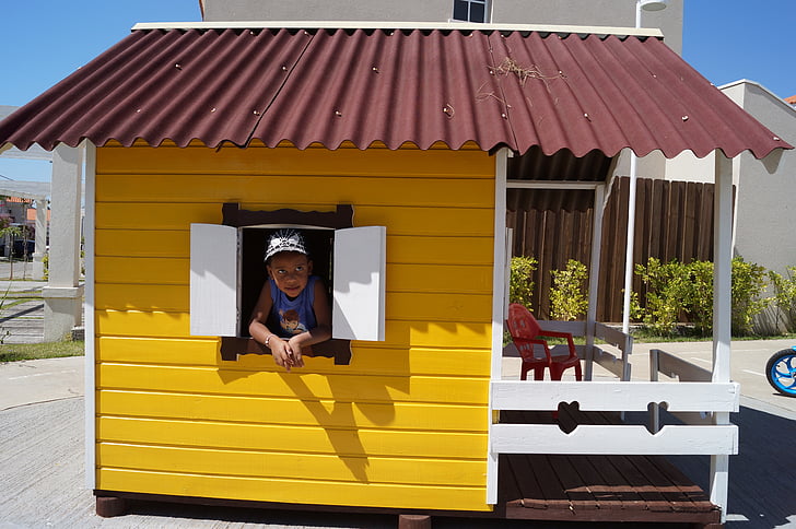 yellow house, brown roof, white window, little child