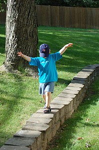 stone wall, child, kid, walking, balancing, balance, cap
