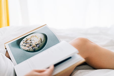 people, woman, lady, book, dish, paper, bed