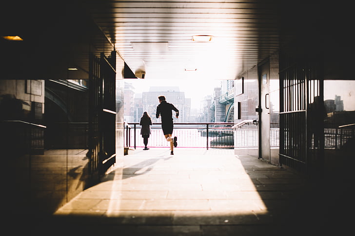 buildings, city, hallway, jogging, light and shadow, man, people