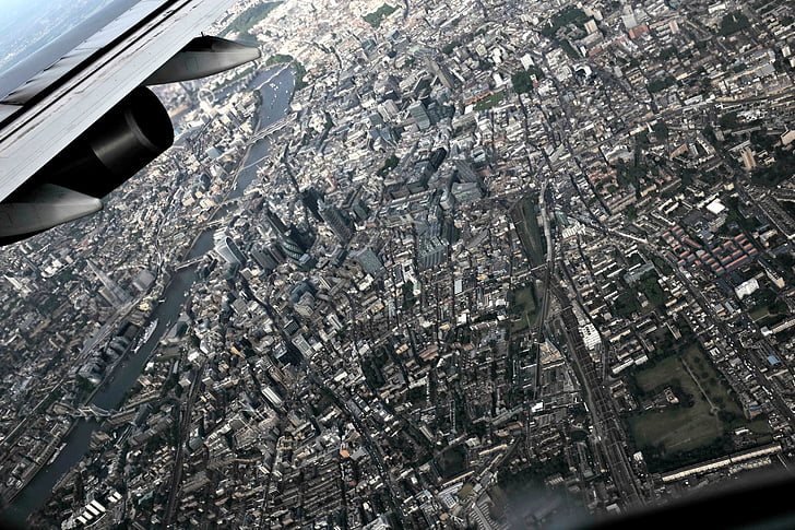 aircraft engine, aircraft wing, bird's eye view, buildings, city, flight, flying
