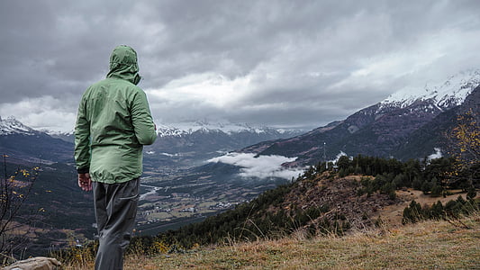 person, green, hoodie, gray, pants, grass, mountains