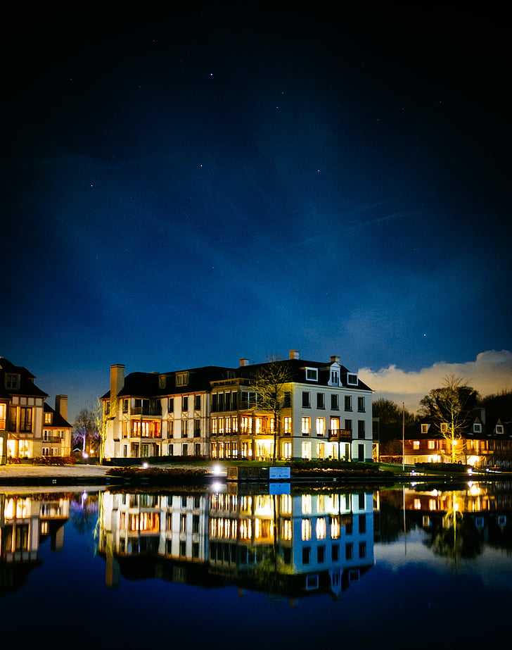 house, lake, lights, night, reflection, sky, village