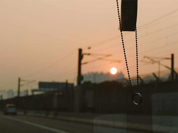 beads, ring, windshield, driving, road, sunset