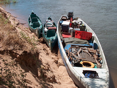 supplies, boat, canoe, zambezi river, river bank, grass, sand