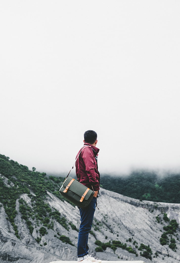 man, carrying, bag, looking, mountains, daytime, guy