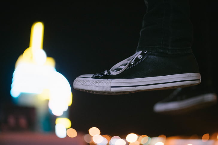 person, wearing, black, sneakers, shoes, floating, lights